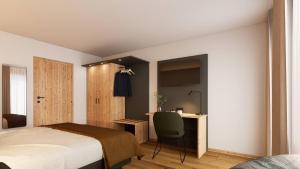 a bedroom with a bed and a desk and a chair at Gasthof Und Hotel Maria Gern in Berchtesgaden