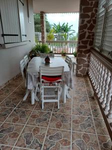 a white table and chairs on a patio at Chez Marino & Charlie in Le Lamentin