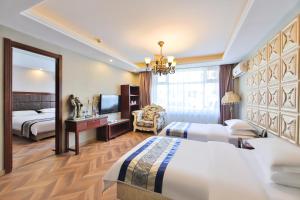 a hotel room with two beds and a mirror at Chaogu Hotel in Changchun +20 photos