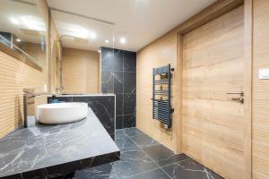 a bathroom with a tub and a sink on a counter at La Perle d'Alsace in Bernardswiller +22 photos