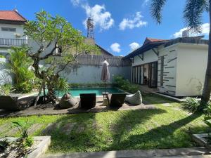 a pool in the backyard of a house at Balcony Living Apartment in Seminyak