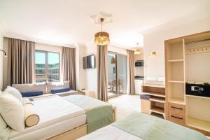 a hotel room with two beds and a tv at Victoria Princess Hotel in Side +184 photos