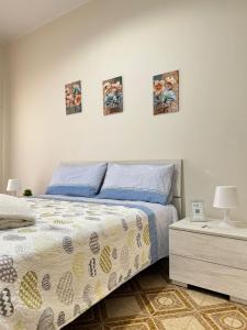 a bedroom with a bed and four pictures on the wall at Alba Vesuviana B&B in Poggiomarino