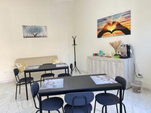 two tables and chairs in a room with a table at Alba Vesuviana B&B in Poggiomarino