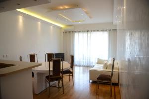 a living room with a couch and a table and chairs at 29 Promenade des Anglais in Nice