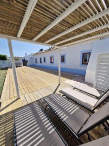 a group of lounge chairs sitting on a patio at Casa Silva in Zambujeira do Mar +55 photos