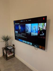 una grande TV a schermo piatto appesa a un muro di Glenariff Forest Getaway a Glenariff
