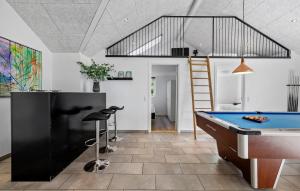 a living room with a pool table and a ladder at Lovely Home In Gørlev With Sauna in Reersø