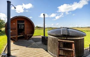 a small wooden building with a round roof at Lovely Home In Gørlev With Sauna in Reersø +9 photos