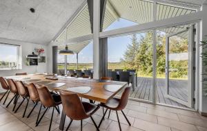a large dining room with a long table and chairs at Lovely Home In Gørlev With Sauna in Reersø