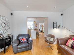 a living room with a couch and a chair at Pebble Cottage in Cullercoats