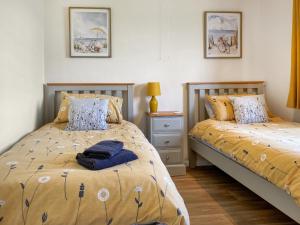 a bedroom with two beds and a night stand at Ivy - Uk47373 in Burgh le Marsh