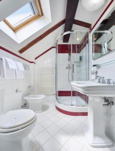 a bathroom with a shower and a toilet and a sink at La Fenice in Prague +29 photos