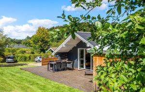 a patio with a table and chairs in a yard at 2 Bedroom Beautiful Home In Egernsund in Egernsund
