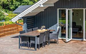 a patio with a table and chairs on a deck at 2 Bedroom Beautiful Home In Egernsund in Egernsund +9 photos