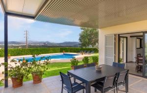 a patio with a table and chairs and a pool at S'ametllerar in Artá