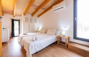 a bedroom with a large bed and a large window at S'ametllerar in Artá