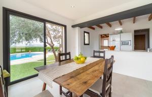 a kitchen and dining room with a table with fruit on it at S'ametllerar in Artá +25 photos
