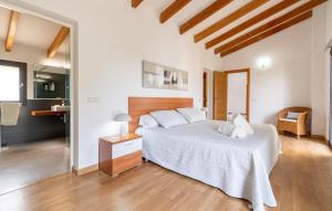 a bedroom with a large bed and a bathroom at S'ametllerar in Artá