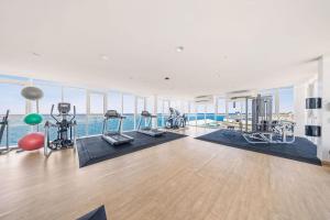an apartment gym with a view of the ocean at Modern Design Studio Ready For Enjoyment in Oranjestad