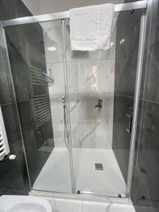 a shower with a glass door in a bathroom at Giovi's Apartments ROOM in Castellammare di Stabia