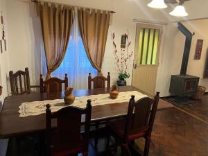 a dining room table with vases on top of it at Tu casa1 - Frente in General Pacheco