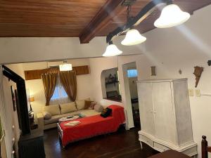 a living room with a couch and a red bed at Tu casa1 - Frente in General Pacheco