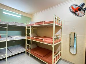 a room with bunk beds and a mirror at An Homestay 2 in Phan Thiet +14 photos