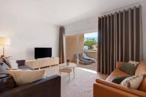a living room with two couches and a television at Apartamento T3 Santa Luzia - H in Santa Luzia