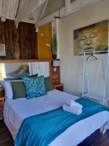 a bedroom with a large bed with blue pillows at Strand Hotel in Strand