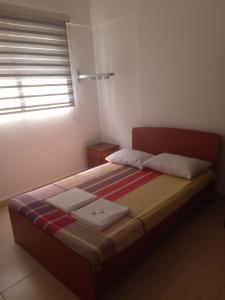 a bedroom with a bed with two towels on it at SkyLine 19 Apartment in Colombo