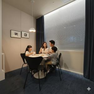a family sitting at a table in a dining room at THE EXTAY Lounge Jongno in Seoul