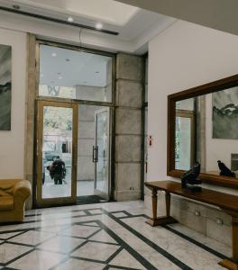 a living room with a table and a mirror at Millennium between 5th floor in Mendoza
