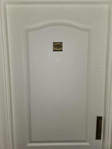 a white door with a picture on it at Millennium between 5th floor in Mendoza