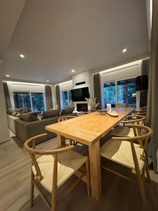 a living room with a wooden table and chairs at eleni's villa in Kandhíla