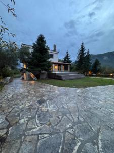 a large stone patio in front of a house at eleni's villa in Kandhíla