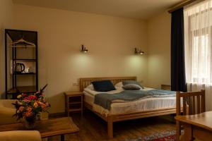 a bedroom with a bed with blue pillows on it at Saryan Guesthouse in Goris