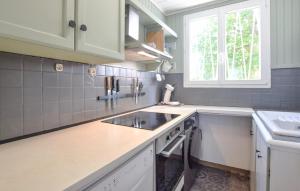 a kitchen with a sink and a window at 3 Bedroom Awesome Home In Cabourg in Cabourg