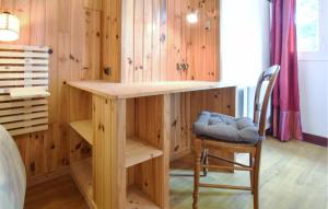 a desk in a room with a chair and a bed at 3 Bedroom Awesome Home In Cabourg in Cabourg +26 photos