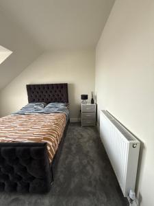 a bedroom with a large bed and a night stand at Birch view getaway in Dunshaughlin