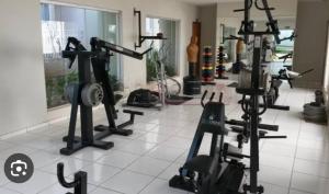 a gym with several treadmills and machines in a room at Luxury Central in Araçatuba