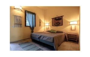 ein Schlafzimmer mit einem Bett und zwei Lampen an der Wand in der Unterkunft Awesome Apartment In Briatico With House Sea View in Sant'Irene-Briatico