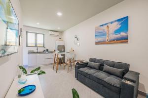 a living room with a couch and a kitchen at Private Suite HotTub in Santa Cruz