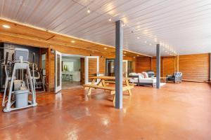 a living room with a table and a gym at Group Retreat Fairhope in Fairhope