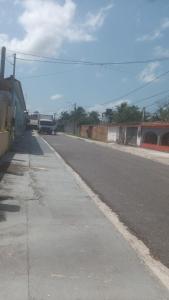 an empty street with a truck driving down the road at Cunhas II Áreas COP30 Moskeiro Belém in Belém