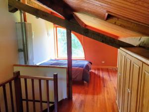 an attic bedroom with a bed and a window at Villa Elorrio in Elorrio