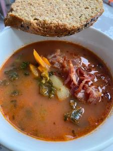 a bowl of soup with a slice of bread at Комната in Wakefield