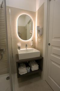 a bathroom with a sink and a mirror at Elysium Relais in Naples +57 photos