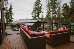 a balcony with couches and a view of a house at Sequim Bay Hideaway in Sequim