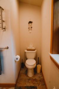 a bathroom with a toilet with a face on the wall at Sequim Bay Hideaway in Sequim
